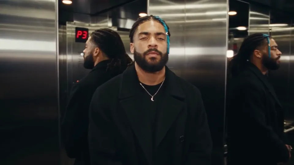 The tied-back hair ref with one blue loc, added to the shots after early takes dyed all his hair blue.